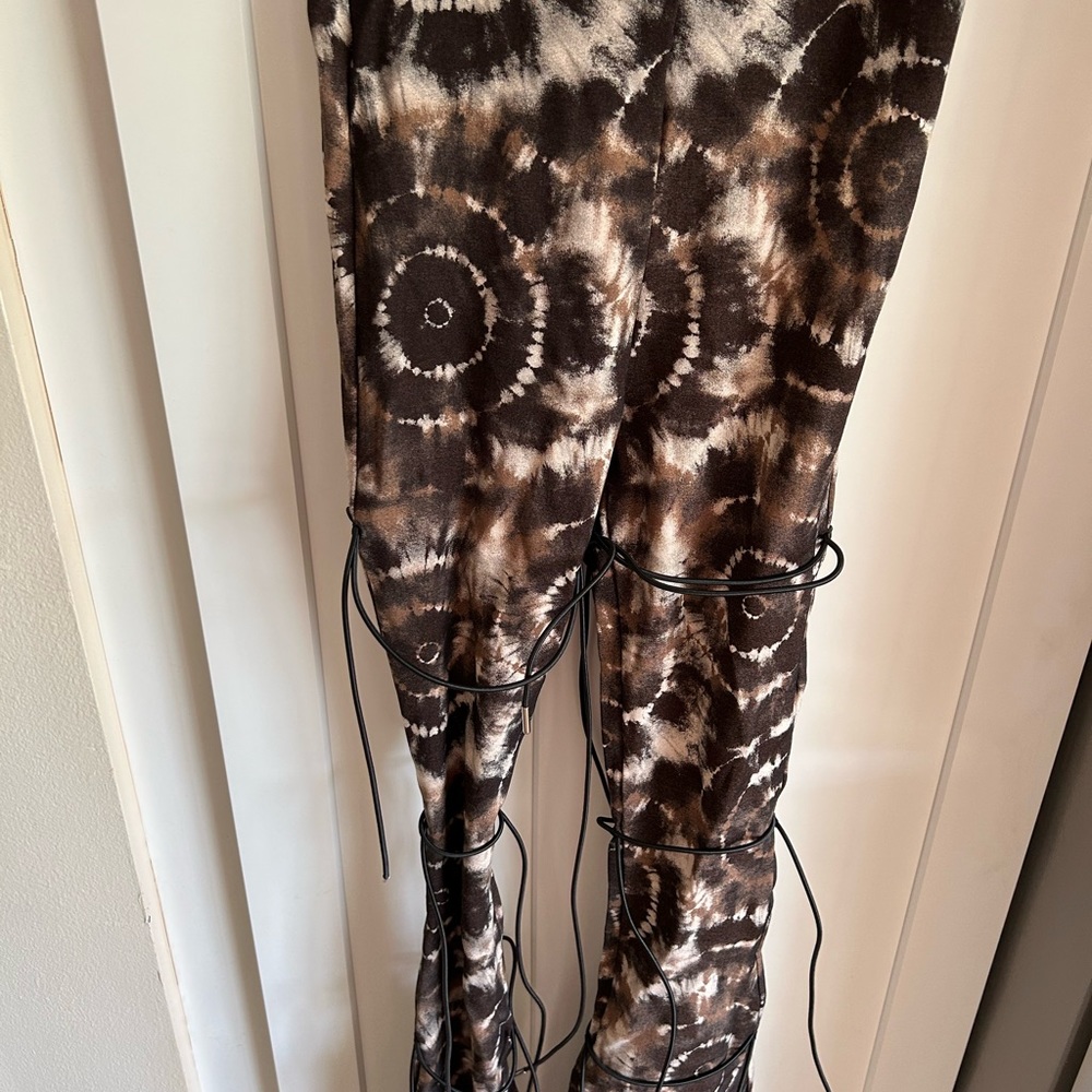 Size 4 stretchy material- never worn- adjustable ties go down the legs-